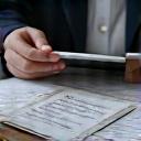 Vital Zenith expert meticulously reviewing product labels and certifications with a magnifying glass.