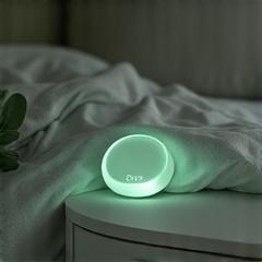 Sleek, minimalist sleep tracking device on a bedside table, subtly glowing.